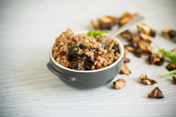 boiled buckwheat with vegetables and dried forest mushrooms in a ceramic mold