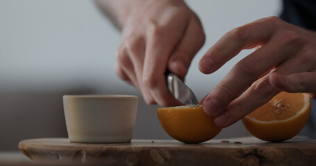 man cut sweet lemon on olive board