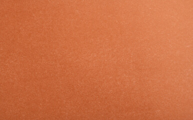 Abstract red glossy paper texture background or backdrop. Empty wrapping paper or shiny paperboard for decorative design element. Grainy surface for Christmas holiday or Chinese new year concept