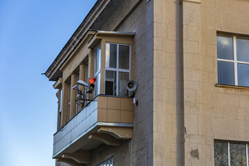 Old stone balcony with traffic lights. Part of an old industrial building