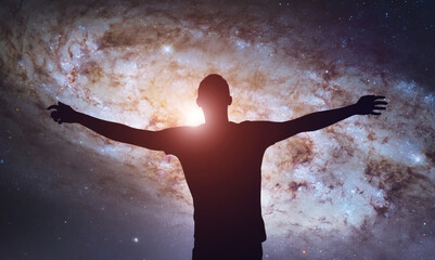 Silhouette of man stand and see in the night sky with stars. Galaxy and space. Light from the chest. Astrology sign. Esoterica and psychology  © dimazel