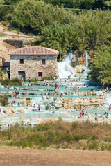 The gorgeous natural thermal bath of Saturnia. Warm water spills out of the rock creating a...