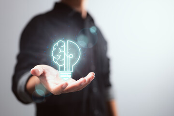 Smart thinking idea and inspiration innovation concept of a businessman holding half of a virtual...