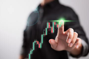 Stock market, business growth, advancement or success concepts, planning and strategy Touching a developing virtual hologram stock, a businessman or trader invests in trading.