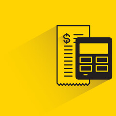 bill and calculator with shadow on yellow background