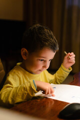 Childhood, cute boy drawing art at home. Happy child creativity.