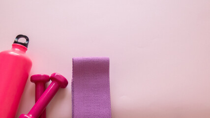 gym utensils on pink background