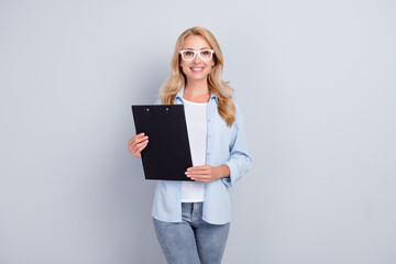 Fototapeta premium Photo of positive manager lady hold clipboard wait client wear specs blue shirt isolated grey color background