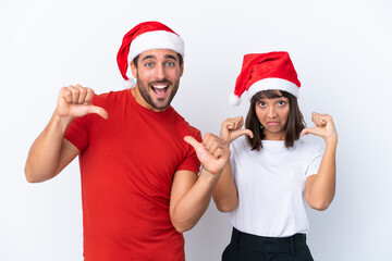 Young couple with christmas hat isolated on white background proud and self-satisfied in love yourself concept