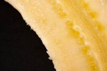 Macro Fruit: Ripe banana extreme close-up, horizontal format, black background