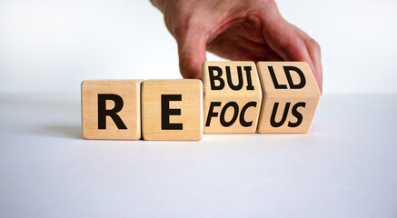 Refocus and rebuild symbol. Businessman turns cubes and changes the word 'refocus' to 'rebuild'....