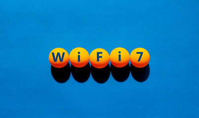 WiFi 7 symbol. The concept word WiFi 7 on orange table tennis balls. Beautiful blue table, blue...