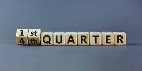From 4th to 1st quater symbol. Turned wooden cubes and changed words '4th quater' to '1st quater'. Beautiful grey table, grey background. Business, happy 1st quater concept, copy space. - obrazy, fototapety, plakaty