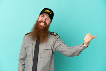 Redhead security man isolated on white background giving a thumbs up gesture
