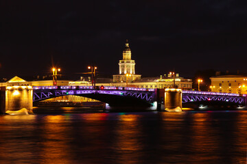 Fototapeta na wymiar City night landscape with a view of the Palace Bridge, the night illumination and reflections in the Neva river.