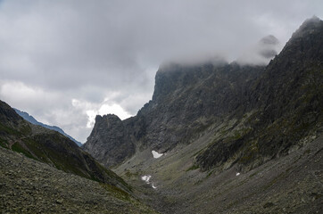 Scenic view of cloudy rainy rocky High Tatras mountains covered in fog. Natural landscape in Slovakia