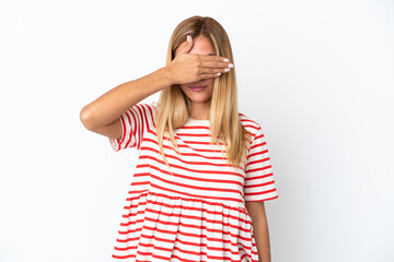 Blonde Uruguayan girl isolated on white background covering eyes by hands. Do not want to see...
