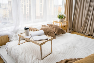 good mornind. cup of coffee in bed. Close up. In beige interior. mock up card