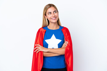 Super Hero caucasian woman isolated background looking up while smiling