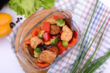 raw chicken marinated with vegetables in a glass dish 