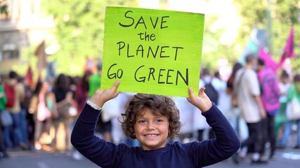 Italia, Milano , Activist boy Child 7 years old with sign Save the Planet , go green - Friday for...