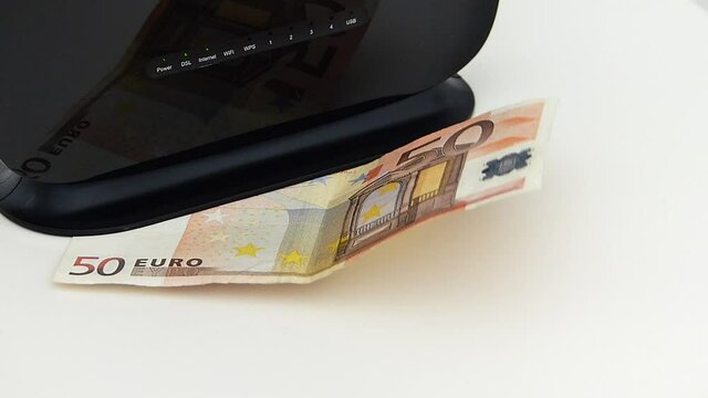 Internet usage fee increase during covid-19 period, modem and 50 euros stand next to it,