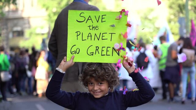 Italia, Milano , Activist boy Child 7 years old with sign Save the Planet , go green - Friday for Future Youth 4 Climate - student demonstration against climate change and global warming 