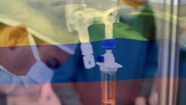 Animation of flag of colombia waving over surgeons in operating theatre