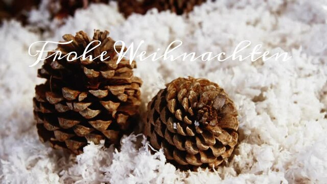 Animation of german greeting text over snow and pine cones christmas decorations