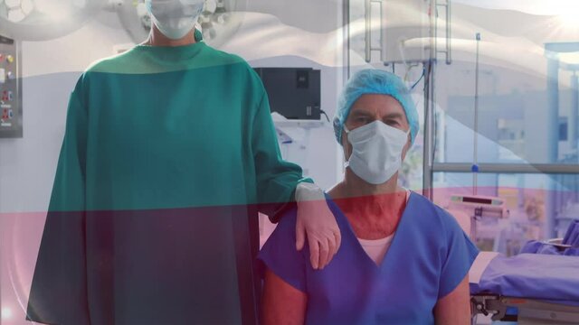 Animation of flag of russia waving over surgeon in operating theatre