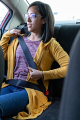 A woman buckling her seat belt