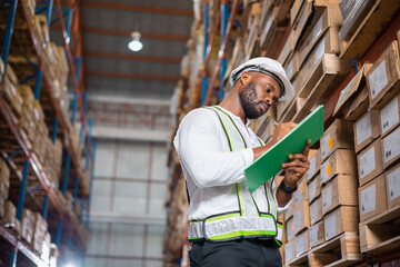 Warehouse man supervisor checking stock in storage warehouse