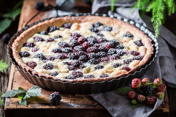 Sweet and delicious tart with blackberries with caster cugar
