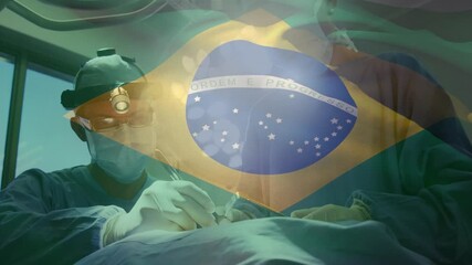 Animation of flag of brazil waving over surgeons in operating theatre - Powered by Adobe