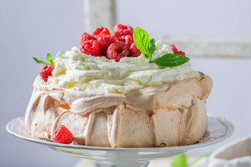 Delicious Pavlova cake with berries and cream.