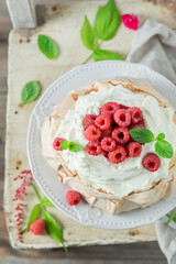 Sweet Pavlova cake with berries and cream.