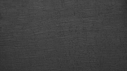 Background and texture of black decorative rough plaster  close-up
