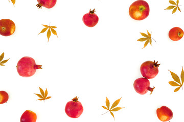 Pomegranate with apple and fall leaves on white background. Flat lay