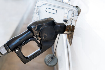 Nozzles in the gas station. A diesel dispenser that is filling up with a car that stops for fuel during the trip.