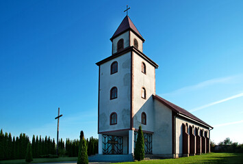 Naklejka premium General view and close-up of architectural details of the Catholic Auxiliary Church of Our Lady of Ostra Brama in Sędki in Masuria in Poland.