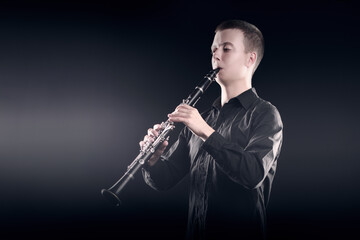 Clarinet player classical musician portrait. Clarinetist playing woodwind - obrazy, fototapety, plakaty
