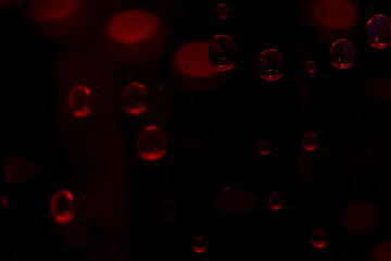 Background of water droplets on the surface with black and red.