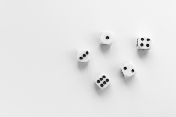 Gaming dice on white background. Playing cube with numbers. Items for board games. Flat lay, top view with copy space.