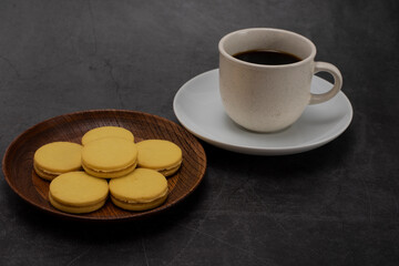 black coffee and cookies on a dark background.