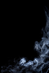 The smooth movement of white smoke on a black background at corner, abstract things on a black background.