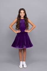 happy smiling teen girl with long curly hair dancing in ballroom dress full length, pose