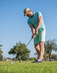 concentrated golfer in cap with golf club, golfing