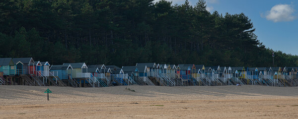 Fototapeta na wymiar Colourful beach huts at Wells-next-the-Sea