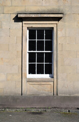 Fototapeta na wymiar Close Up of Old Victorian Window in Stuccoed Wall 
