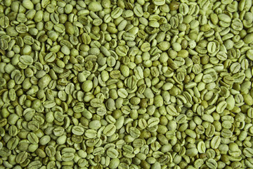 Pile of green coffee beans as background, closeup